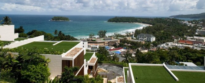 Aerial view of Kata Beach in Phuket with modern villas and a clear coastal shoreline.