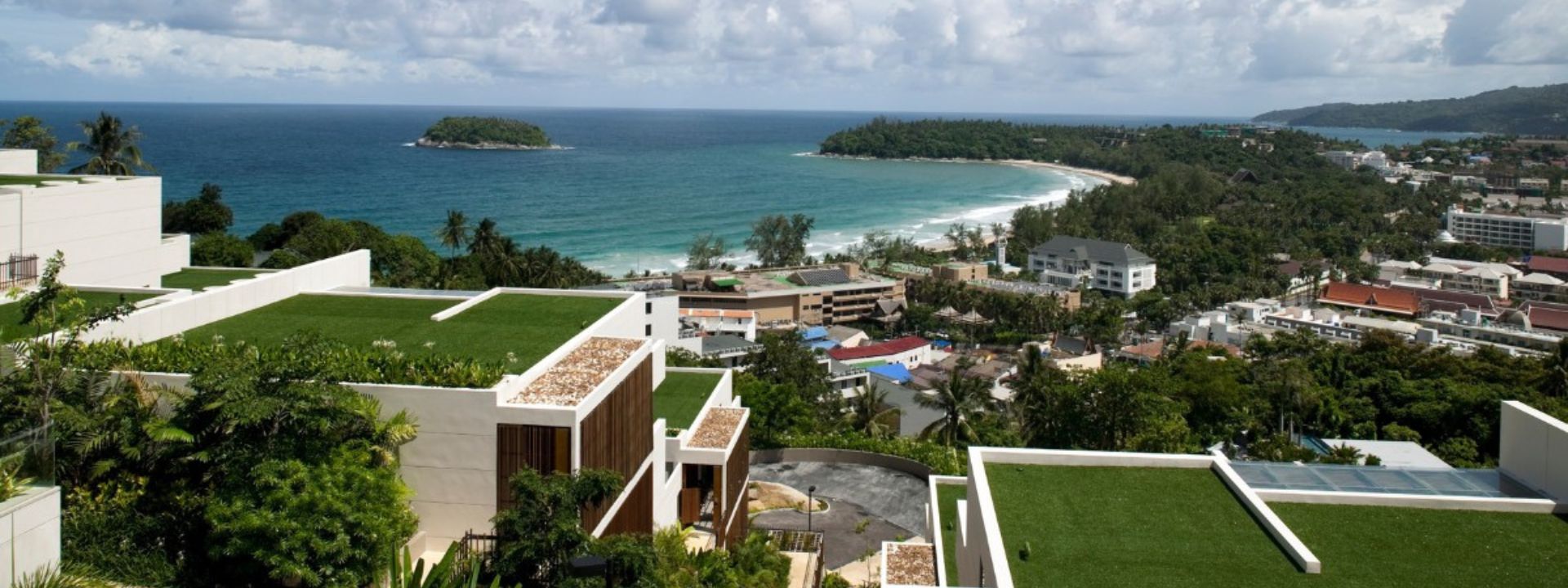 Aerial view of Kata Beach in Phuket with modern villas and a clear coastal shoreline.