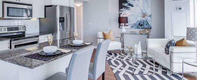 Modern condo interior with open-plan kitchen and living room, illustrating typical condominium design in Phuket.