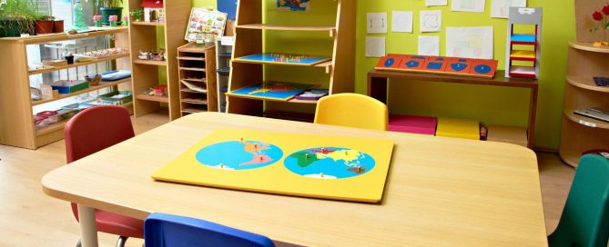 Colorful preschool classroom with educational materials and artwork on the walls