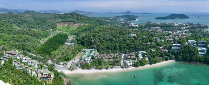 Aerial view of coastal developments and residential projects in Phuket, showing areas where buyers evaluate property developers.