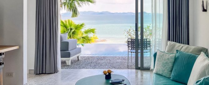 Condo living room in Phuket with an ocean view through large sliding doors.