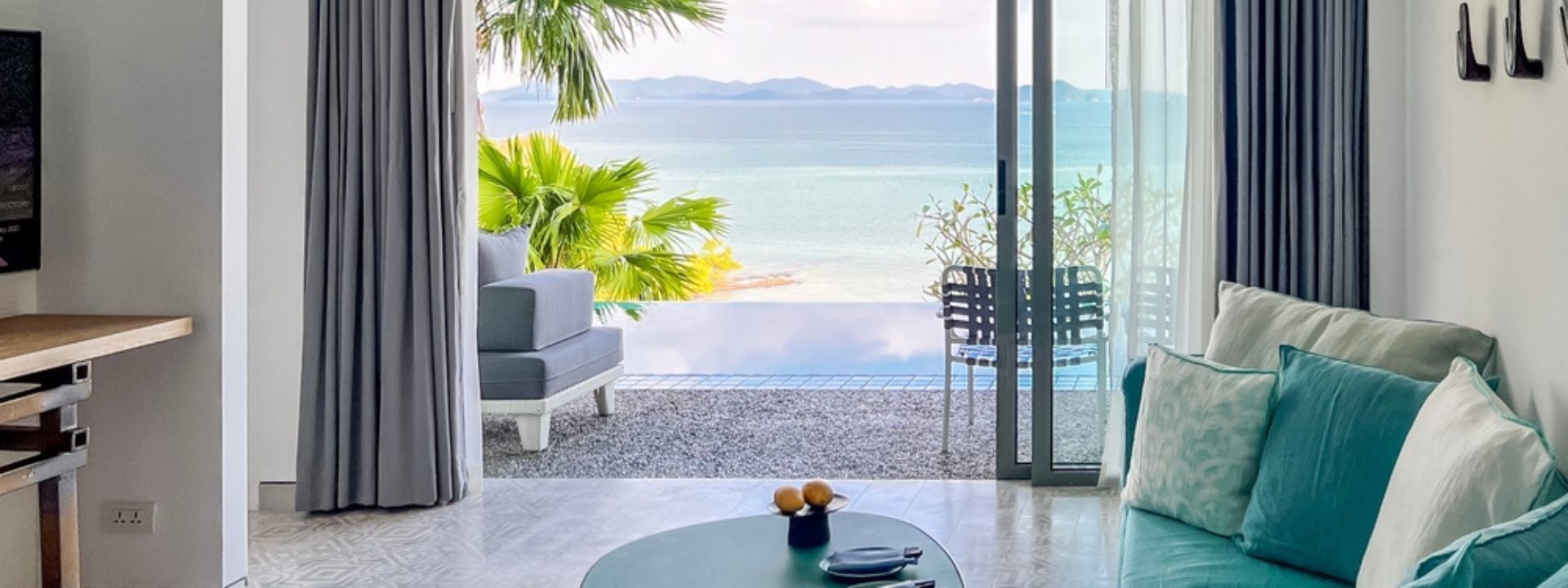 Interior of a Phuket condominium with ocean view and shared amenities, illustrating lifestyle supported by condo common area fees.