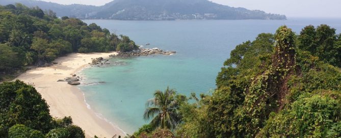 Aerial view of Laem Singh Beach in Phuket with turquoise water and surrounding greenery.