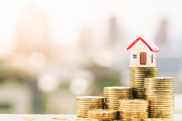 Phuket Property Prices Stay Competitive - image of saving money with pile of coins 
