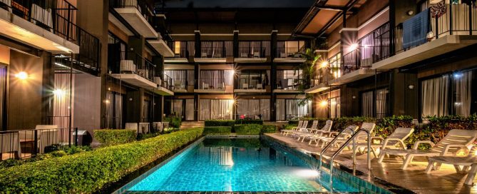 Nighttime view of a condominium swimming pool and surrounding units in Phuket.