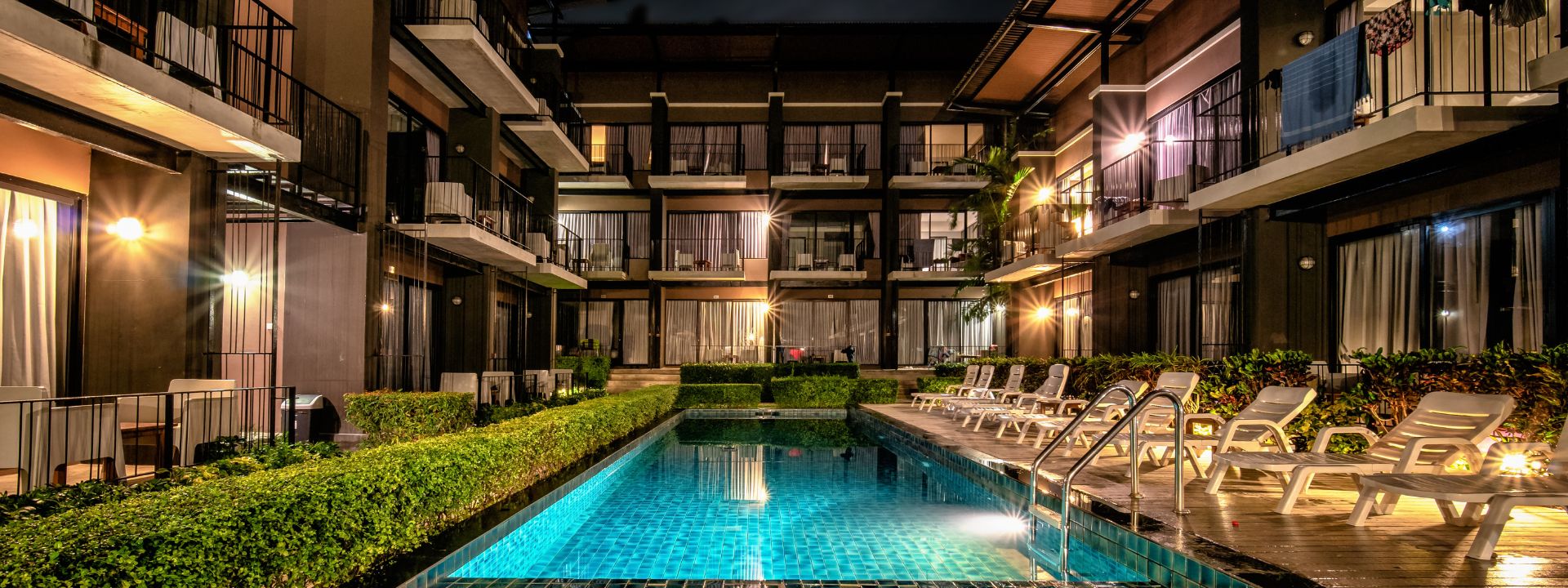 Nighttime view of a condominium swimming pool and surrounding units in Phuket.