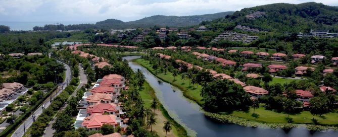 Aerial view of Bangtao’s lakeside villas and surrounding greenery in Phuket
