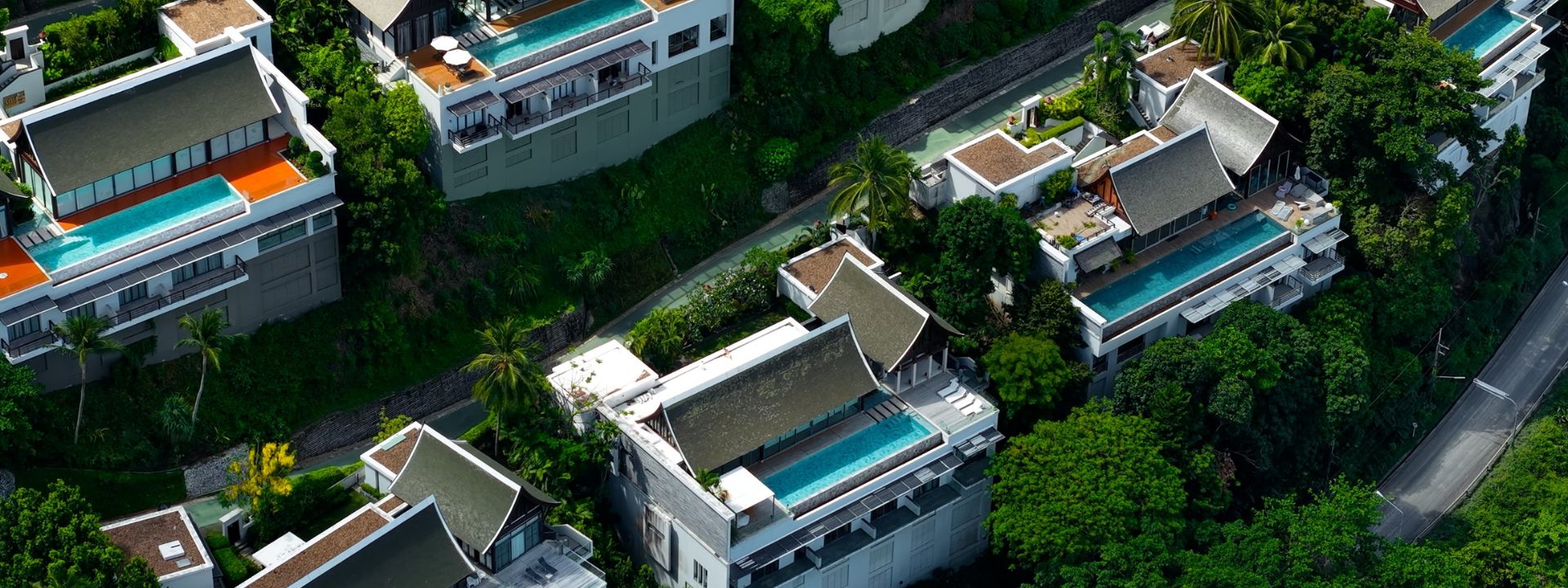 Hillside luxury villas with private pools surrounded by greenery in Phuket