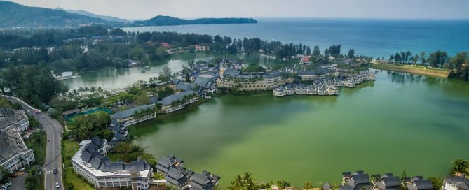 Aerial view of luxury lagoon-side villas and resort residences in Laguna Phuket, highlighting renewed demand for high-end villas and condos