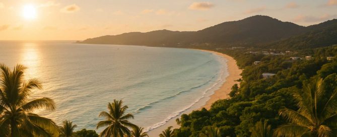 Sunset view along a quiet beach and forested coastline in Phuket