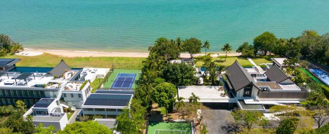 Aerial view of luxury beachfront villas and modern residential development overlooking the sea in Phuket