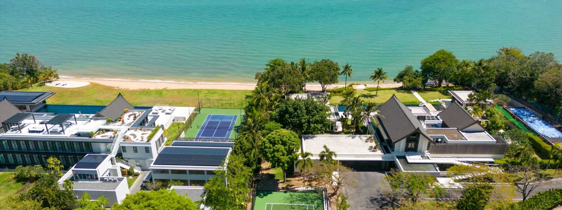 Aerial view of luxury beachfront villas and modern residential development overlooking the sea in Phuket