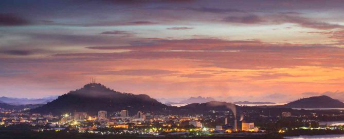 Phuket Town skyline at dusk with hills and coastal landscape in the background