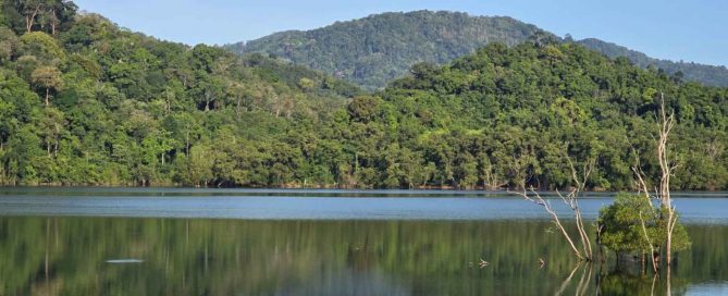 Bang Wad Dam (Kathu Dam) surrounded by lush green forested hills in Phuket, Thailand