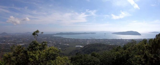 Panoramic hilltop view overlooking Chalong Bay, Phuket, with the coastline and surrounding islands
