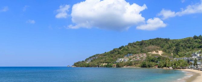 Kamala Beach coastline with hillside residential developments overlooking the bay in Phuket