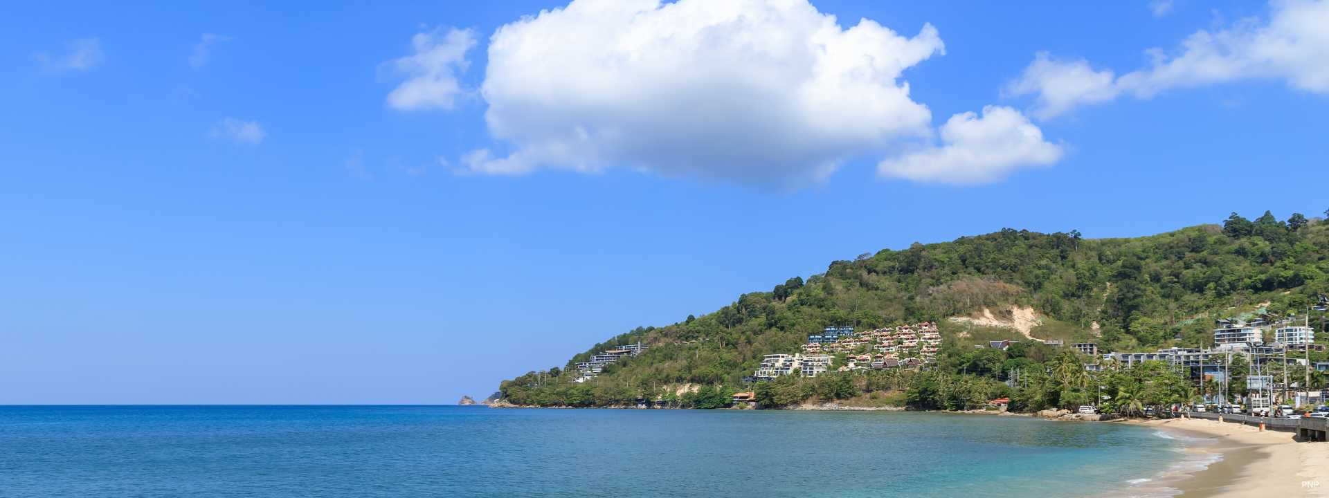 Kamala Beach coastline with hillside residential developments overlooking the bay in Phuket
