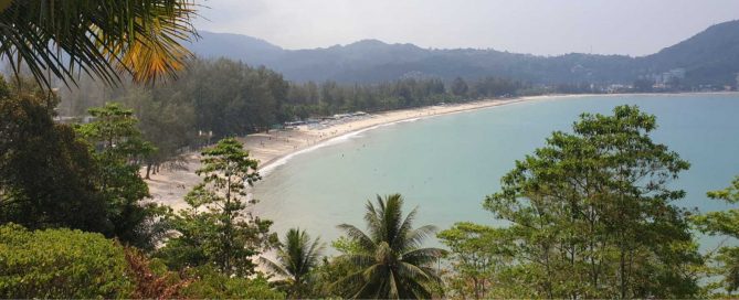 Panoramic view of Kamala Beach in Phuket showing the bay, shoreline, and surrounding hills