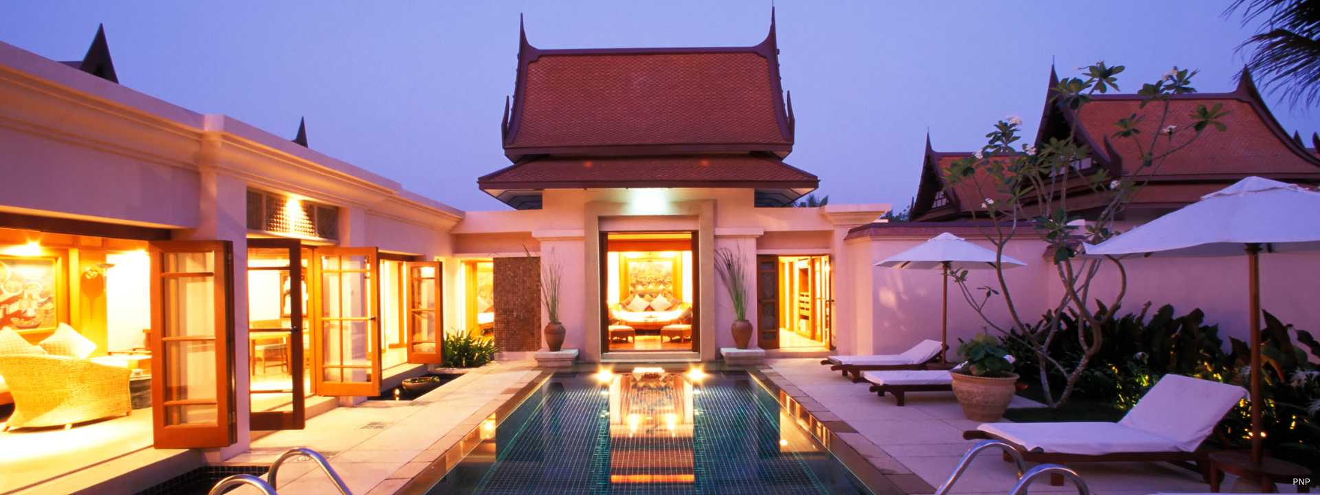 Luxury Thai-style villa in Phuket with private swimming pool at dusk