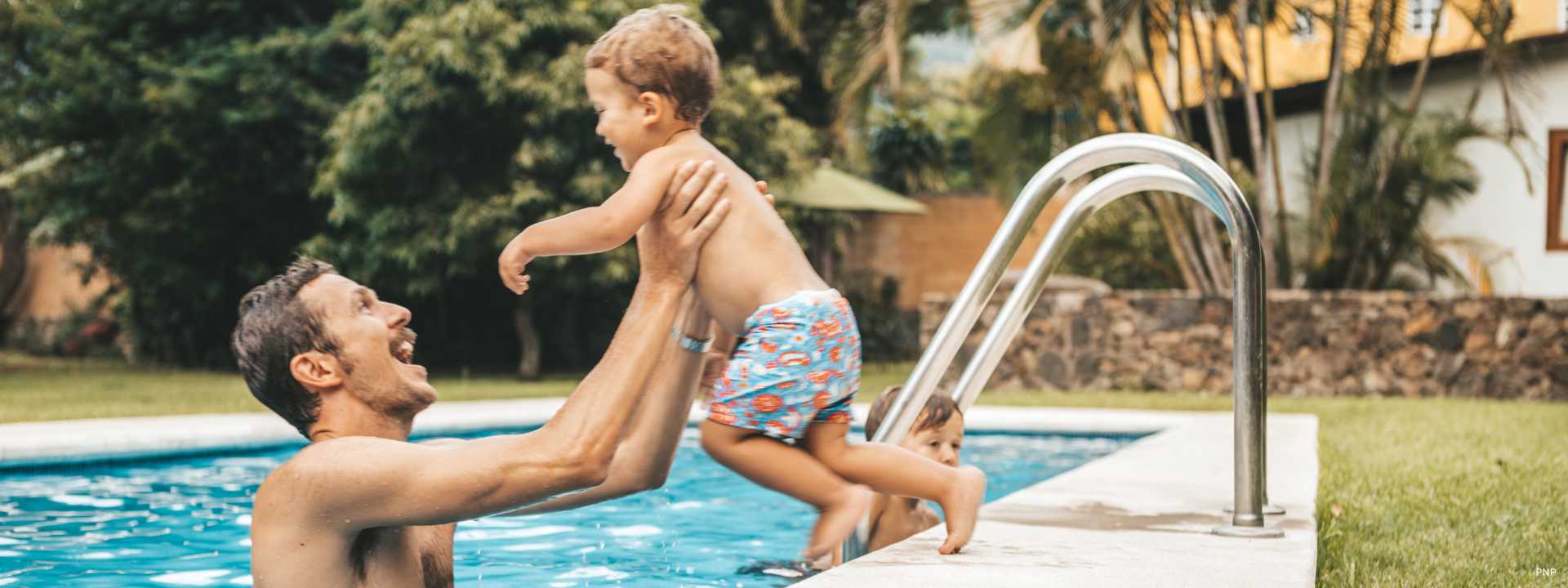 Family enjoying private swimming pool at a residential villa in Phuket