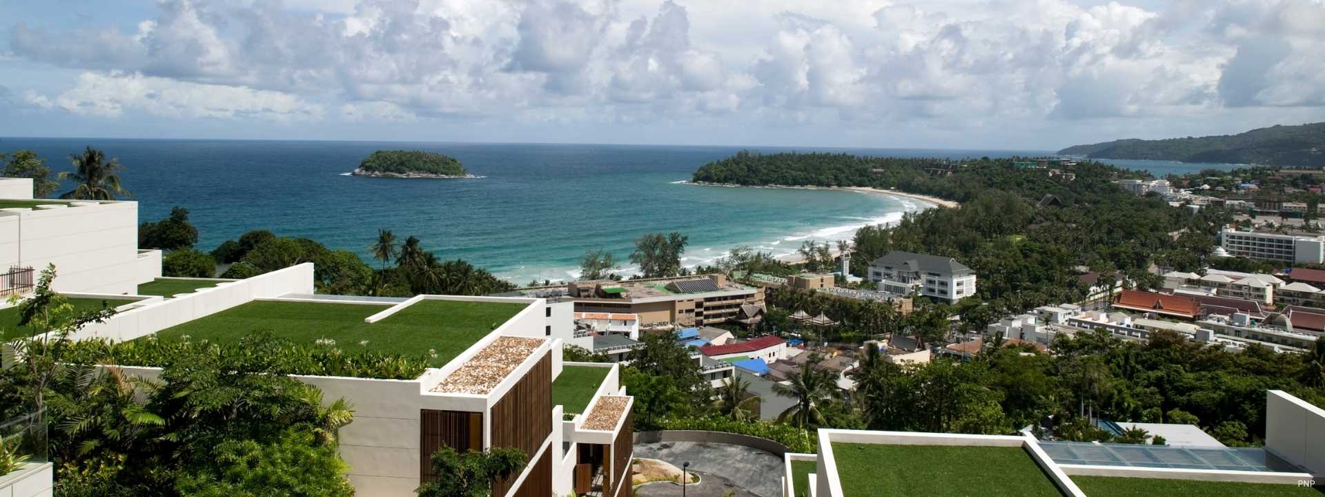 Elevated hillside residential development overlooking a coastal bay in Phuket