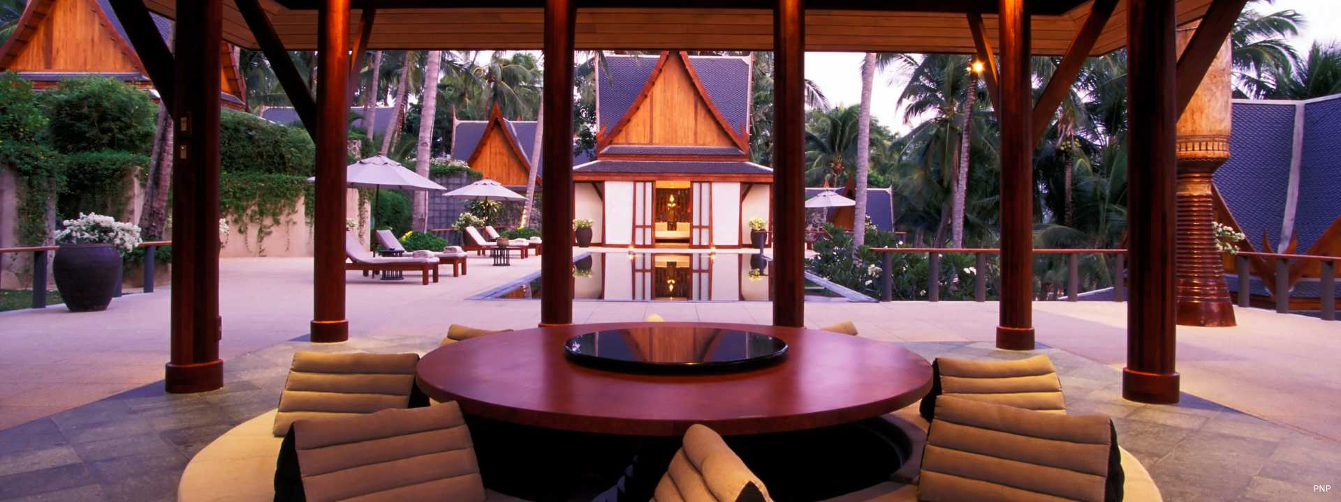 Luxury Thai-style villa courtyard in Phuket with pavilion seating and private pool