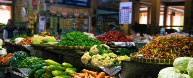 Fresh vegetables and colorful chili peppers at a traditional Phuket local market
