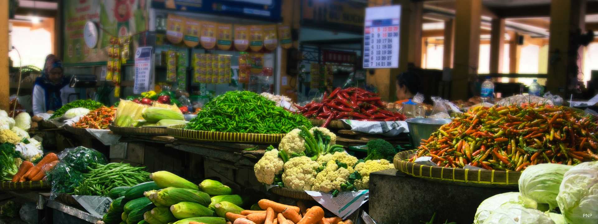 Fresh vegetables and colorful chili peppers at a traditional Phuket local market