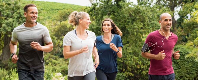 Group of adults jogging outdoors in a green park environment in Phuket