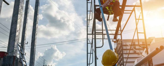 Construction workers on scaffolding at a building site with safety helmets, steel framework, and urban surroundings