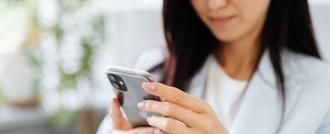 Business professional using a smartphone indoors