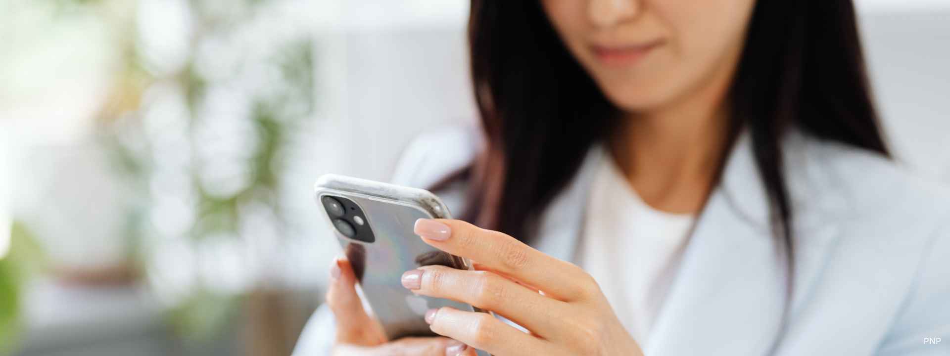 Business professional using a smartphone indoors