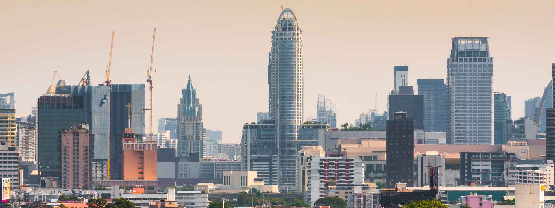 Bangkok skyline with condo developments and construction cranes representing Thailand’s property market